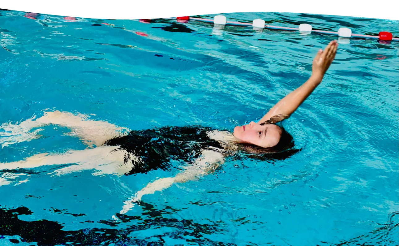 Kind schwimmt Rücken in der Walgruppe im Becken der Aquarena Neunkirchen-Seelscheid