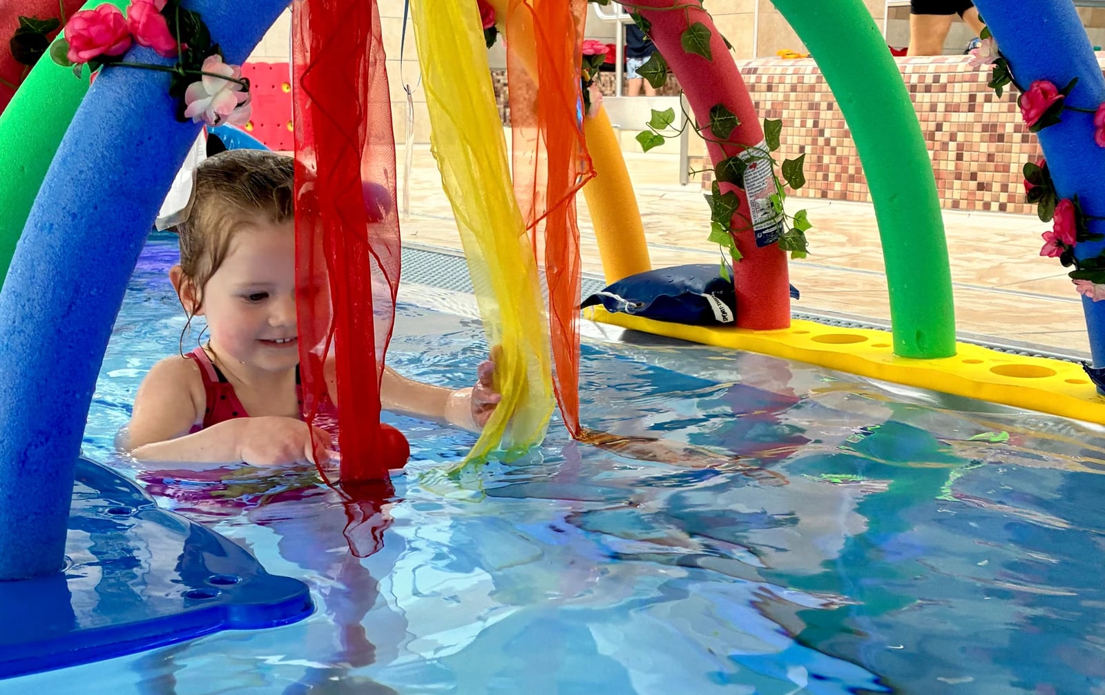 Kind und Elternteil üben gemeinsam im Lehrschwimmbecken der Aquarena